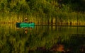 Fisherman row in green rubber boat