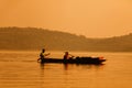 Fisherman rowing for fish in the sunset