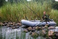 Fisherman on rubber boat catching fish on the lake. Hobby. Royalty Free Stock Photo