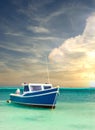 Fishing boat anchored in a peaceful bay in Aruba under dramatic sky Royalty Free Stock Photo