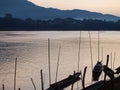 Fisherman`s Boats Silhouette On Smooth Water Surface At MEKONG RIVER In LUANG PRABANG Province,  LAOS