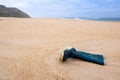 Fisherman`s boot left on the sand at empty beach Royalty Free Stock Photo