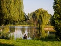 Fisherman's chair and fishing rod in the background over the lake at dawn. Royalty Free Stock Photo