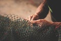 fisherman`s hand, repairing fishing net