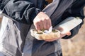 The fisherman`s hands are holding a plastic box with a variety of lures and fishing hooks Royalty Free Stock Photo