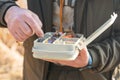 The fisherman's hands are holding a plastic box with a variety of lures and fishing hooks Royalty Free Stock Photo