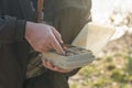 The fisherman's hands are holding a plastic box with a variety of lures and fishing hooks Royalty Free Stock Photo