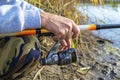 Fisherman`s hands keep spinning rod Royalty Free Stock Photo