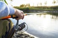 Fisherman`s hands keep spinning rod Royalty Free Stock Photo
