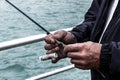 Close-up of a fisherman`s hands using his fishing gear Royalty Free Stock Photo