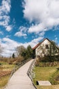 Fisherman`s house with a wooden pedestrian bridge next to the lake. Royalty Free Stock Photo