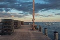 Fisherman`s pier on the bay at sunset. Lobster traps on a pier and boats on the water. USA. Maine.