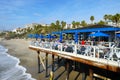 Fisherman`s restaurant on San Clemente Pier with beach and coastline on background.