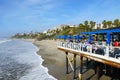 Fisherman`s restaurant on San Clemente Pier with beach and coastline on background.