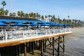 Fisherman`s restaurant on San Clemente Pier with beach and coastline on background.