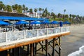 Fisherman`s restaurant on San Clemente Pier with beach and coastline on background.