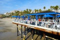 Fisherman`s restaurant on San Clemente Pier with beach and coastline on background.