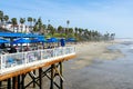 Fisherman`s restaurant on San Clemente Pier with beach and coastline on background.