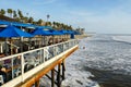 Fisherman`s restaurant on San Clemente Pier with beach and coastline on background.