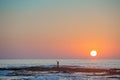 Fisherman's silhouette on seashore