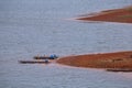 A fisherman\'s wooden boat on the coast, in a reservoir, inside a dam of Thailand Royalty Free Stock Photo