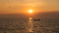 fisherman sailing boat on sea at sunset, Bang Pu, Samut Prakan Royalty Free Stock Photo