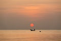 fisherman sailing the boat under a big red sundown Royalty Free Stock Photo