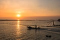 Fisherman sailing fishing boat at sunset in Bang Pu