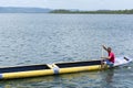 Fisherman sailing with his blue and yellow canoe on the grand Paraguacu river