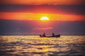 Fisherman sailling with his boat on beautiful sunrise over the s