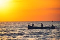 Fisherman sailling with his boat on beautiful sunrise over the sea Royalty Free Stock Photo