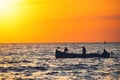 Fisherman sailling with his boat on beautiful sunrise over the sea