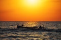 Fisherman sailling with his boat on beautiful sunrise over the sea