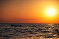 Fisherman sailing with his boat on beautiful sunrise over the sea Royalty Free Stock Photo