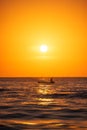 Fisherman sailing with his boat on beautiful sunrise over the sea