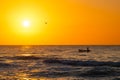 Fisherman sailling with his boat on beautiful sunrise over the sea