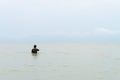 Fisherman in the sea corrects fishing net Royalty Free Stock Photo