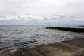 Fisherman at the sea pierce landscape with a lot of clouds. Royalty Free Stock Photo