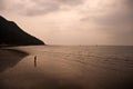 fisherman searching for clams when ebb tide