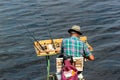 Fisherman on a self-made platform with fishing tackle and rods