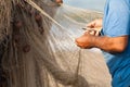 Fisherman is settings up his fishing net at the beach