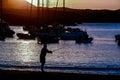 Fisherman silhouette on the beach at colorful sunset, fishing background