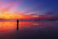 Fisherman silhouette on beach at sunset Royalty Free Stock Photo