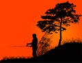 Fisherman silhouette at orange sunset Royalty Free Stock Photo