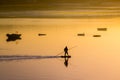 Fisherman silhouette. Sunrise in the harbour of Quellon in Chiloe Island. Patagonia in Chile