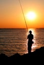 Fisherman silhouette on sunset Royalty Free Stock Photo