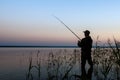 Fisherman silhouette at sunset Royalty Free Stock Photo