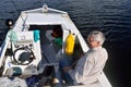 Fisherman sitting in a boat with spinning