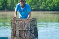 Fisherman in small boat and blue shirt