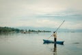 Fisherman in a small boat with his traps on the biggest lake in